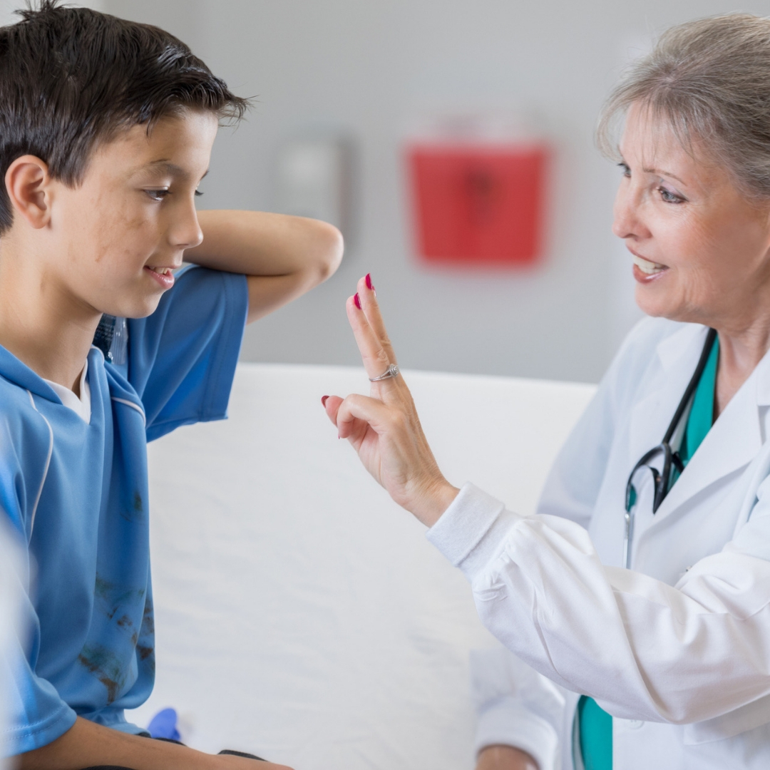 female doctor treating concussion in children