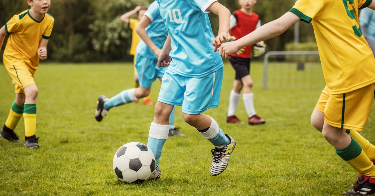 young soccer player dribbling
